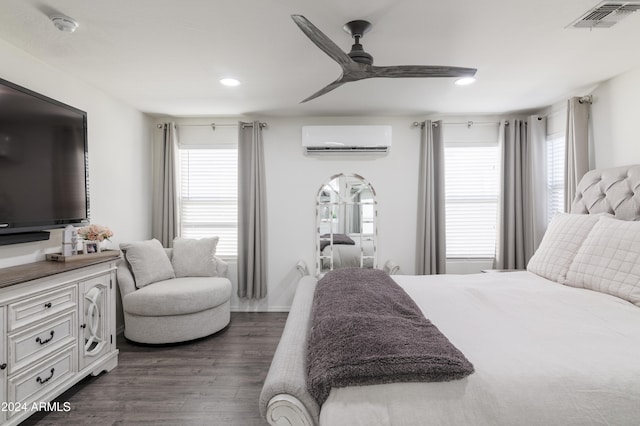 bedroom featuring ceiling fan, a wall unit AC, dark hardwood / wood-style floors, and multiple windows