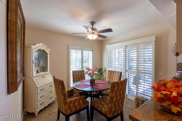 tiled dining room featuring ceiling fan