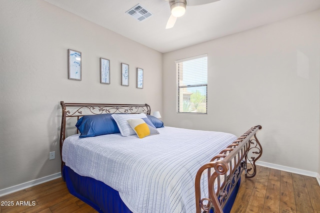 bedroom featuring baseboards, visible vents, wood-type flooring, and ceiling fan