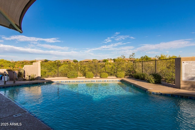 view of swimming pool with a fenced in pool and fence