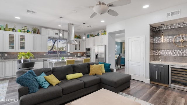 3956 S Hollyhock Pl, Chandler, AZ 85248 - living area featuring wine cooler, visible vents, wood finished floors, and indoor wet bar