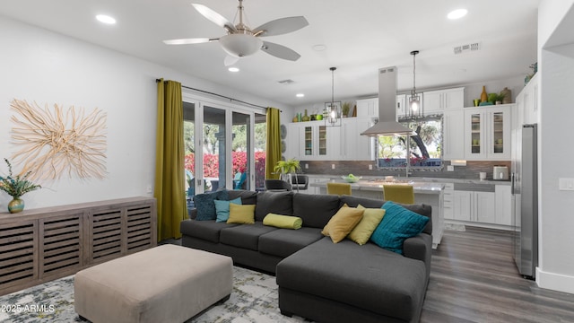 3956 S Hollyhock Pl, Chandler, AZ 85248 - living area with recessed lighting, dark wood-style floors, visible vents, and a wealth of natural light