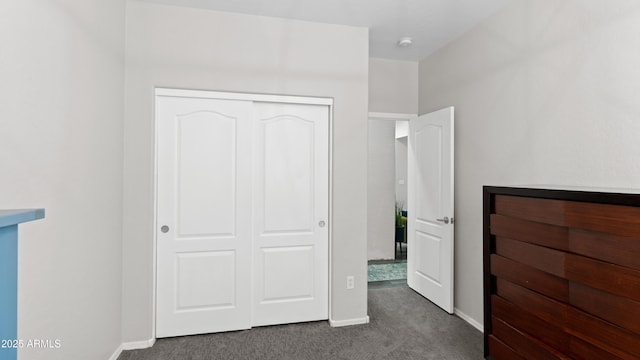 3956 S Hollyhock Pl, Chandler, AZ 85248 - unfurnished bedroom featuring dark carpet, baseboards, and a closet