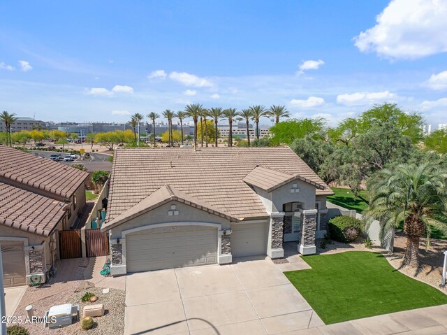 3956 S Hollyhock Pl, Chandler, AZ 85248 - view of front of house featuring a tiled roof, an attached garage, fence, and stone siding