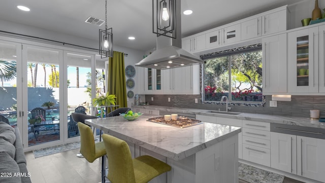 3956 S Hollyhock Pl, Chandler, AZ 85248 - kitchen featuring stainless steel gas cooktop, tasteful backsplash, visible vents, and a kitchen island