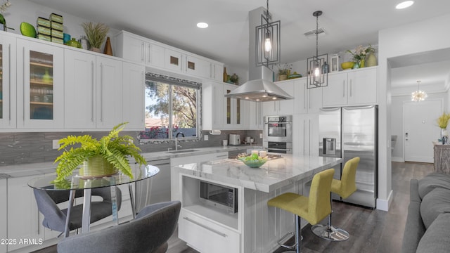3956 S Hollyhock Pl, Chandler, AZ 85248 - kitchen with a sink, a kitchen breakfast bar, recessed lighting, white cabinetry, and stainless steel appliances