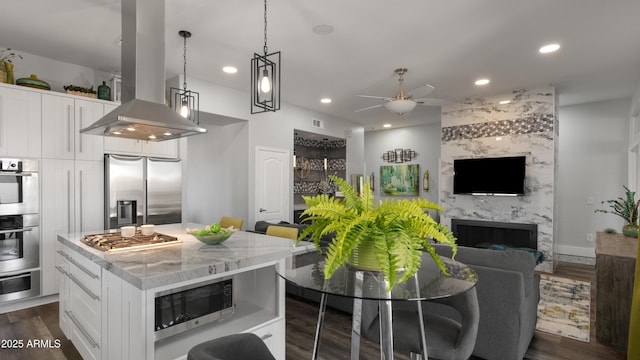3956 S Hollyhock Pl, Chandler, AZ 85248 - kitchen with island exhaust hood, open floor plan, a kitchen island, ceiling fan, and stainless steel appliances