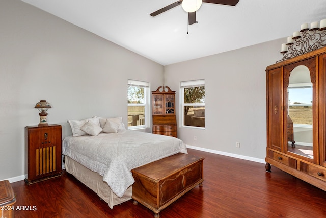 bedroom featuring lofted ceiling, ceiling fan, baseboards, and wood finished floors