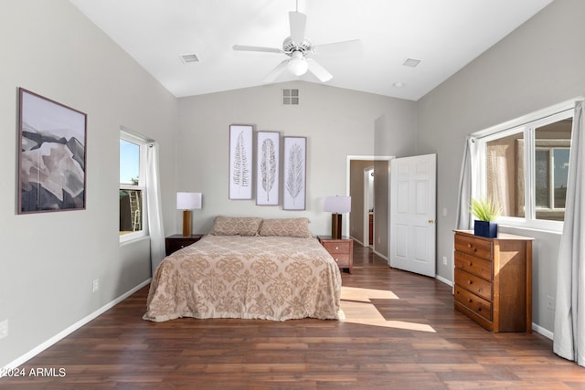 bedroom with lofted ceiling, visible vents, baseboards, and wood finished floors