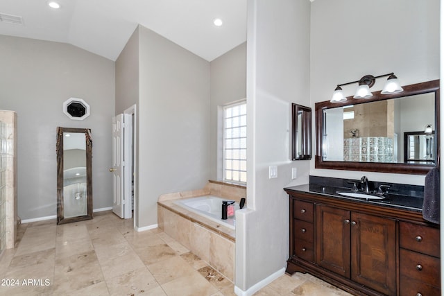 full bath with a garden tub, visible vents, vanity, high vaulted ceiling, and baseboards