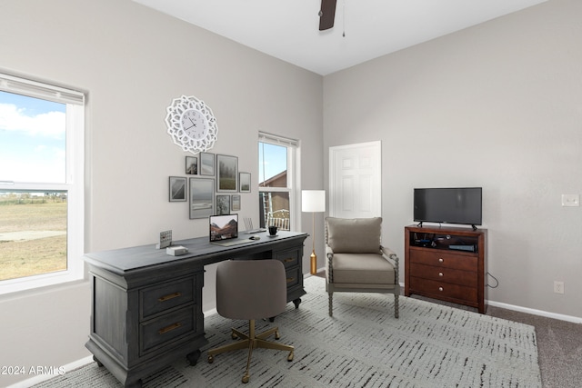 carpeted home office with plenty of natural light, baseboards, and a ceiling fan