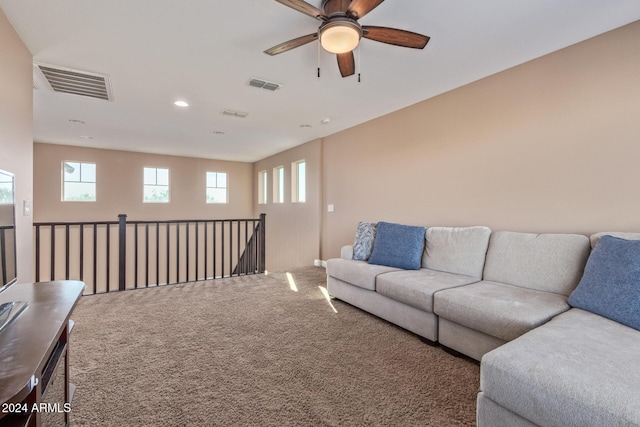 carpeted living room with ceiling fan