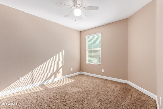 spare room featuring carpet flooring and ceiling fan