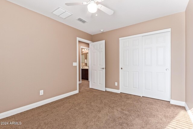 unfurnished bedroom featuring carpet flooring, a closet, and ceiling fan