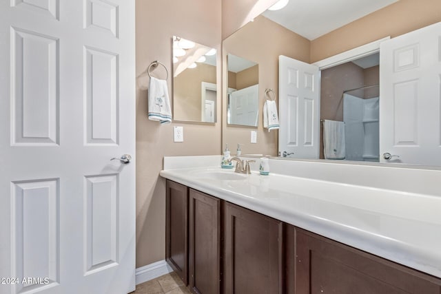 bathroom featuring tile patterned flooring and vanity