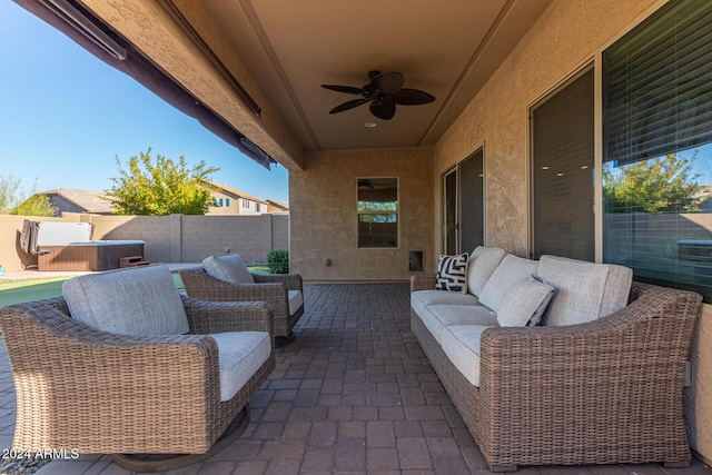 view of patio featuring a hot tub and ceiling fan