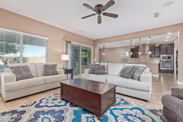 tiled living room with ceiling fan