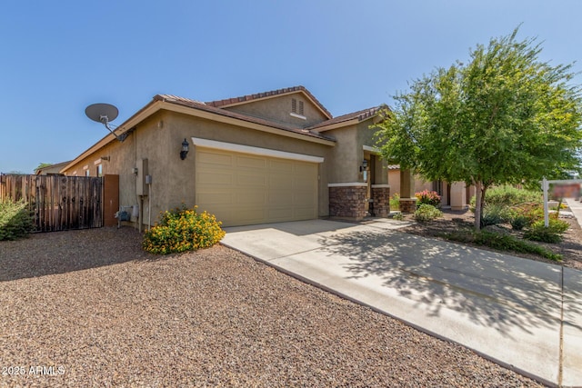 25945 W Runion Dr, Buckeye, AZ 85396 - view of front of property with driveway, a garage, stucco siding, and stone siding