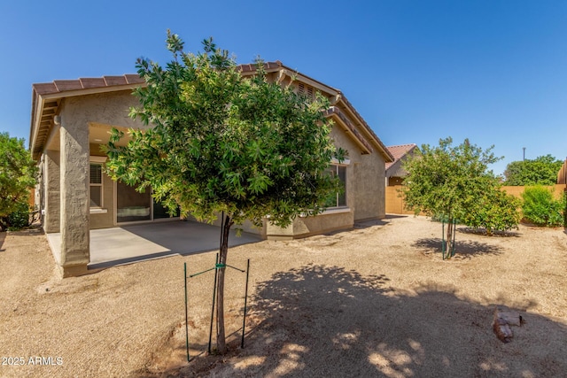 25945 W Runion Dr, Buckeye, AZ 85396 - rear view of house with a patio, stucco siding, and a tiled roof
