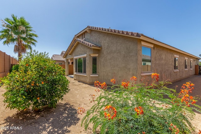 25945 W Runion Dr, Buckeye, AZ 85396 - view of side of property with stucco siding and a tile roof