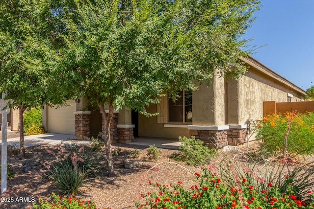 25945 W Runion Dr, Buckeye, AZ 85396 - view of front of house featuring stone siding, stucco siding, and concrete driveway