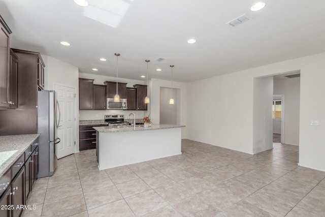 25945 W Runion Dr, Buckeye, AZ 85396 - kitchen featuring stainless steel appliances, recessed lighting, a center island with sink, dark brown cabinets, and light tile patterned floors