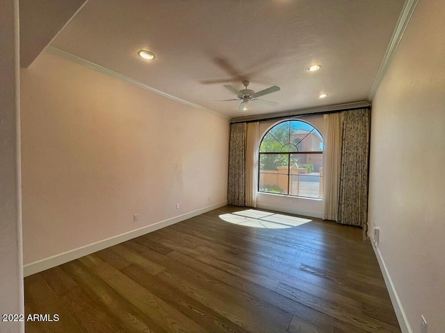 empty room with ornamental molding, ceiling fan, and dark hardwood / wood-style flooring