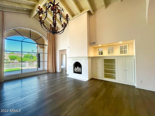 unfurnished living room featuring dark hardwood / wood-style floors, a notable chandelier, and wood ceiling