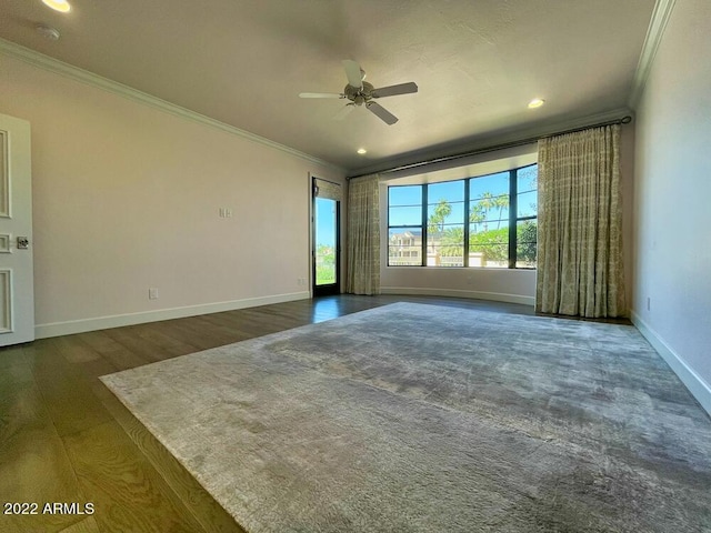 unfurnished room with crown molding, ceiling fan, and dark hardwood / wood-style flooring