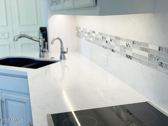 kitchen featuring sink and black electric stovetop