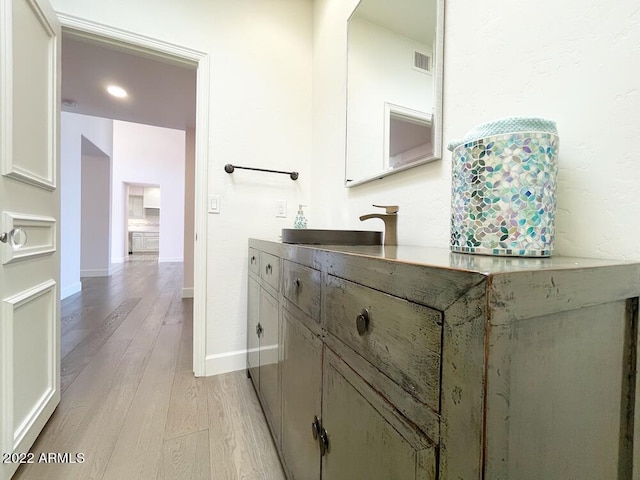 bathroom featuring vanity and hardwood / wood-style floors