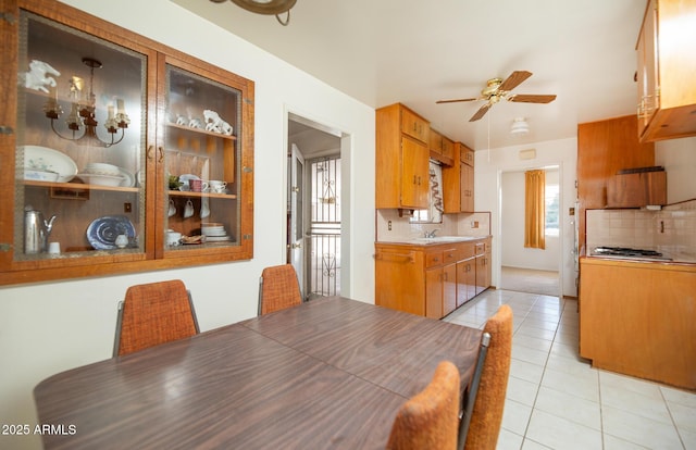 dining area with light tile patterned floors and ceiling fan