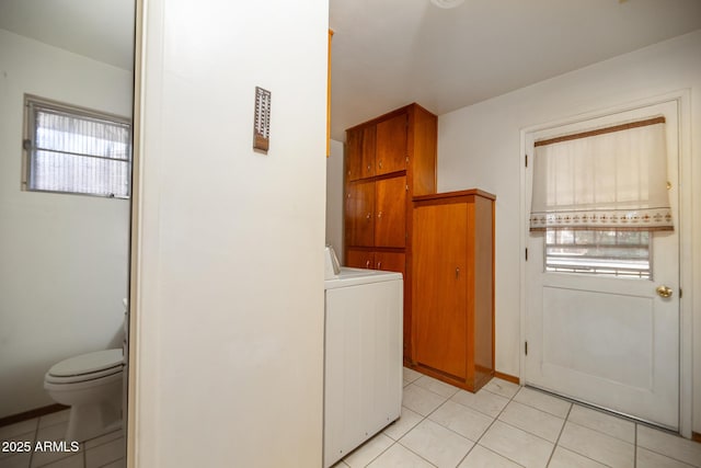 laundry room featuring light tile patterned floors and washer / clothes dryer