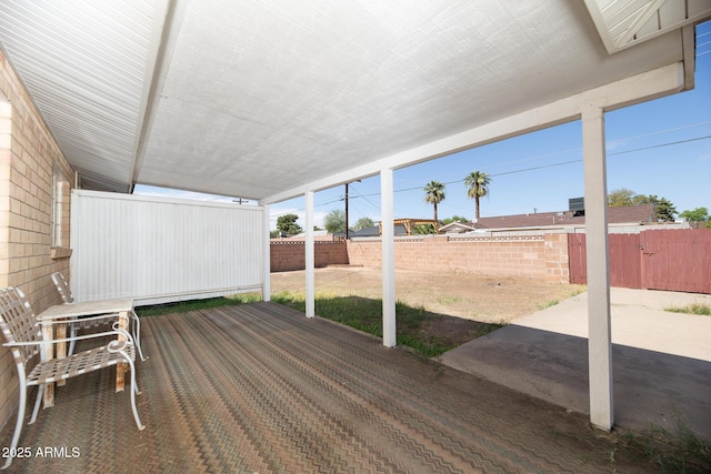 deck with a patio and a fenced backyard