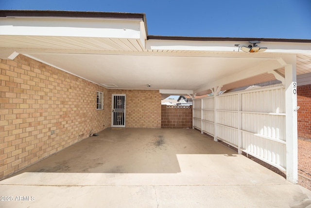 exterior space with an attached carport and fence