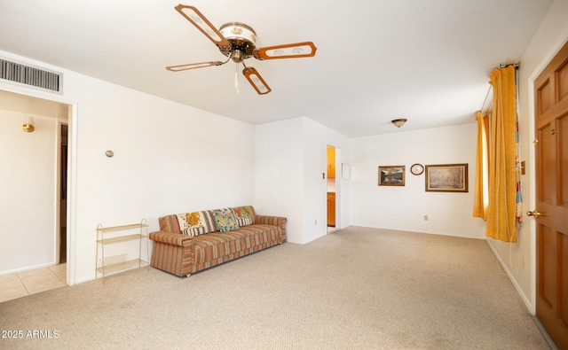 sitting room with visible vents, light colored carpet, and a ceiling fan