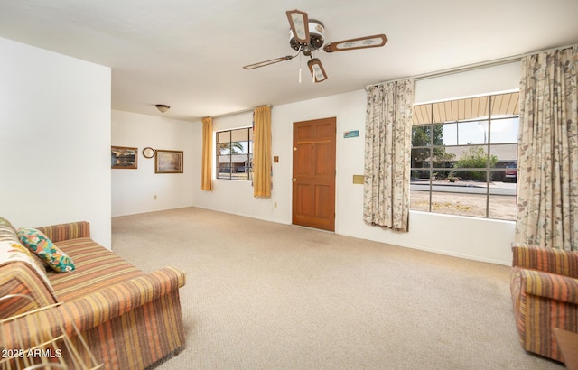 carpeted living room featuring a ceiling fan