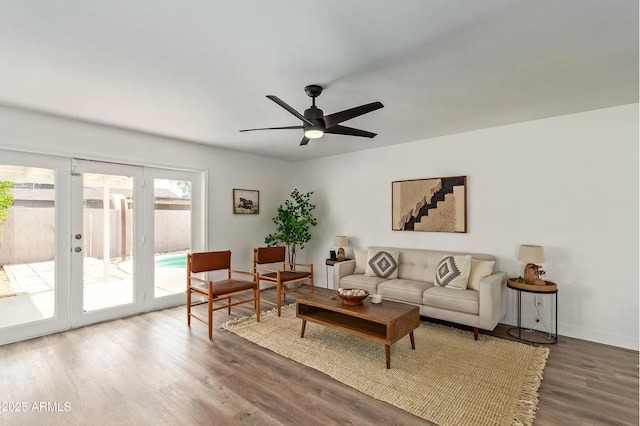 living room featuring hardwood / wood-style flooring, ceiling fan, and french doors