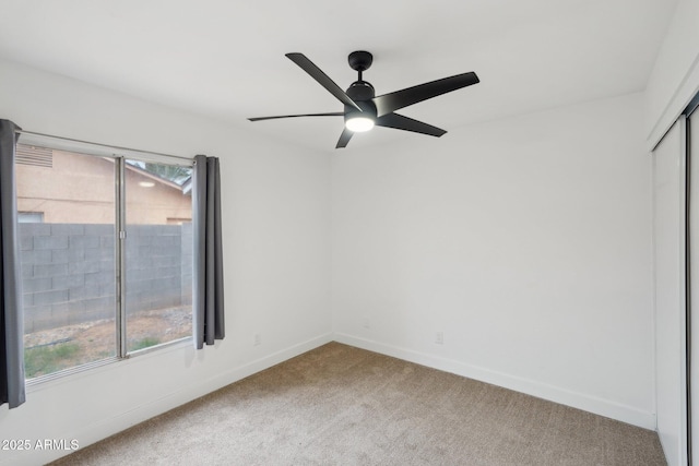 spare room with ceiling fan and carpet flooring