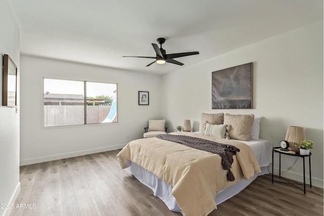 bedroom with hardwood / wood-style floors and ceiling fan