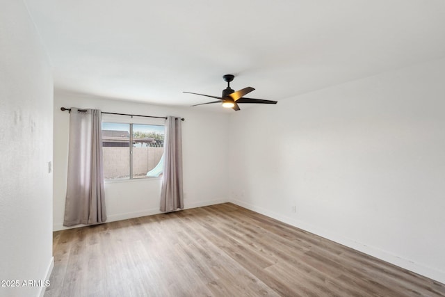 unfurnished room with ceiling fan and light wood-type flooring