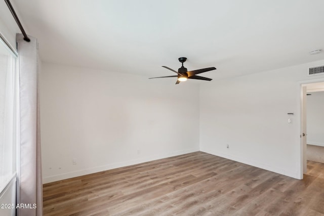 empty room featuring light hardwood / wood-style flooring and ceiling fan