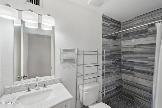 bathroom with vanity, curtained shower, and toilet