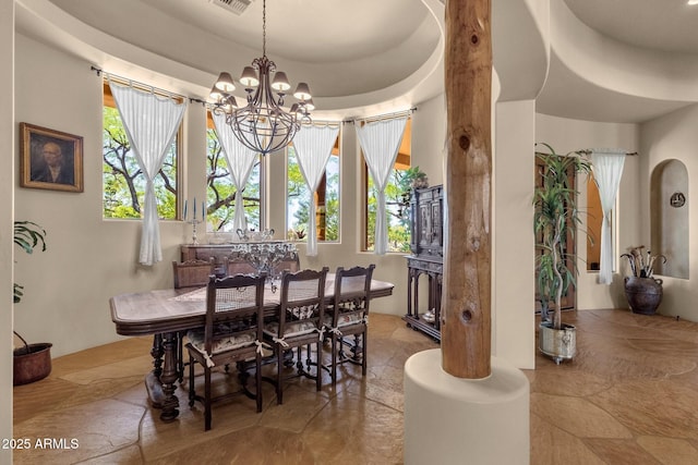 dining space featuring visible vents and an inviting chandelier