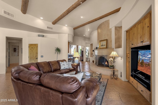 living area with beam ceiling, visible vents, recessed lighting, and a high end fireplace