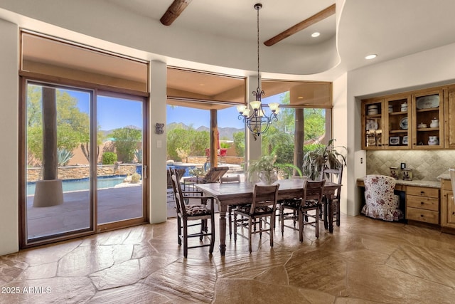 dining space with recessed lighting, a notable chandelier, stone tile flooring, and a healthy amount of sunlight