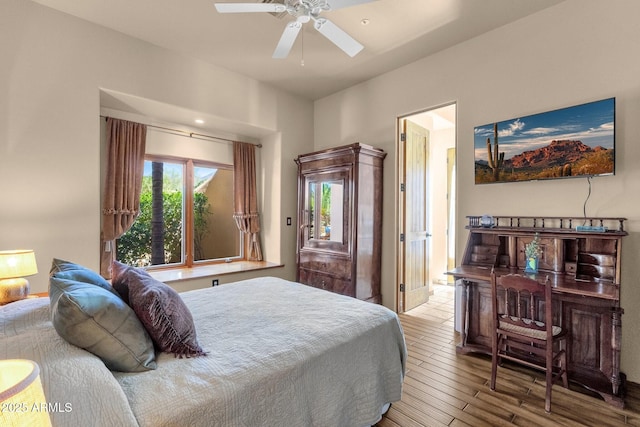 bedroom with a ceiling fan and wood finished floors