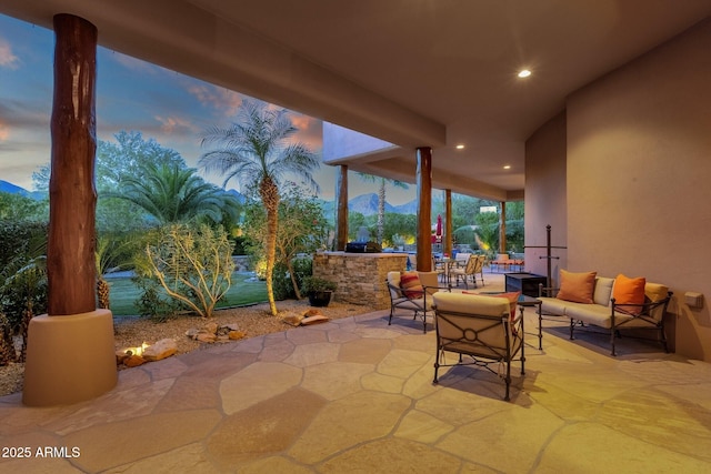 view of patio with outdoor lounge area, a mountain view, and area for grilling
