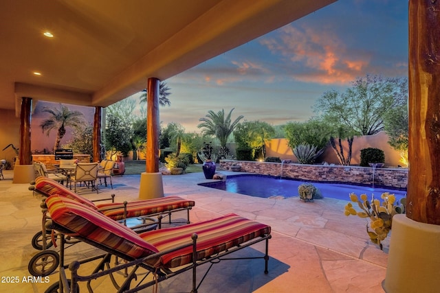 view of pool with a patio, outdoor dining space, a fenced in pool, and a fenced backyard