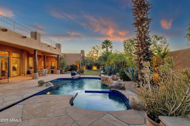 view of pool with a patio and a pool with connected hot tub
